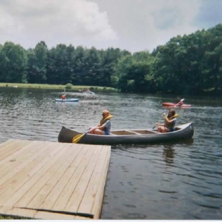 Two people at a 4-H Camp in a canoe 